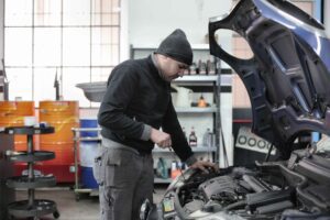 Men is repairing a car